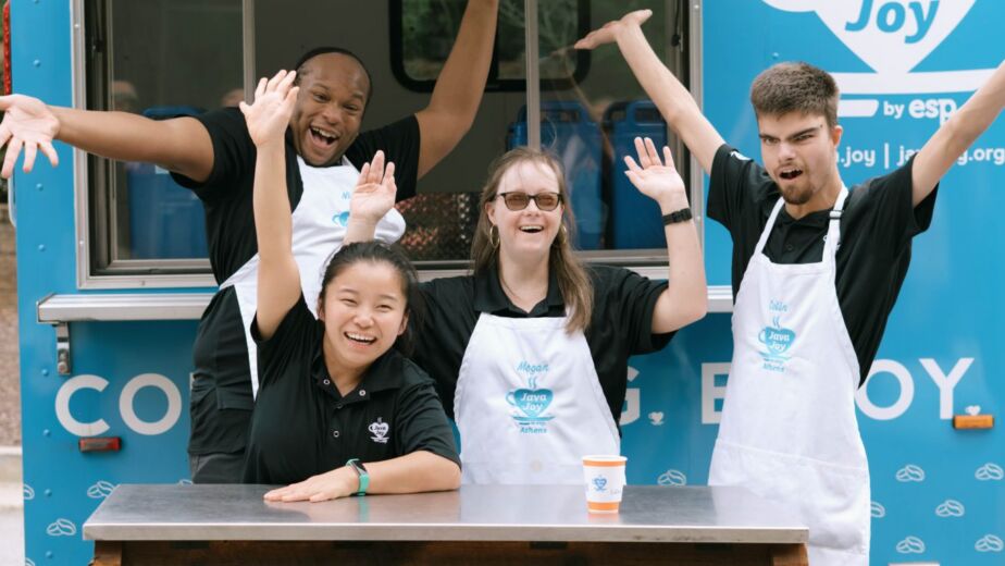 a group of people standing in front of a food truck with Java Joy sign