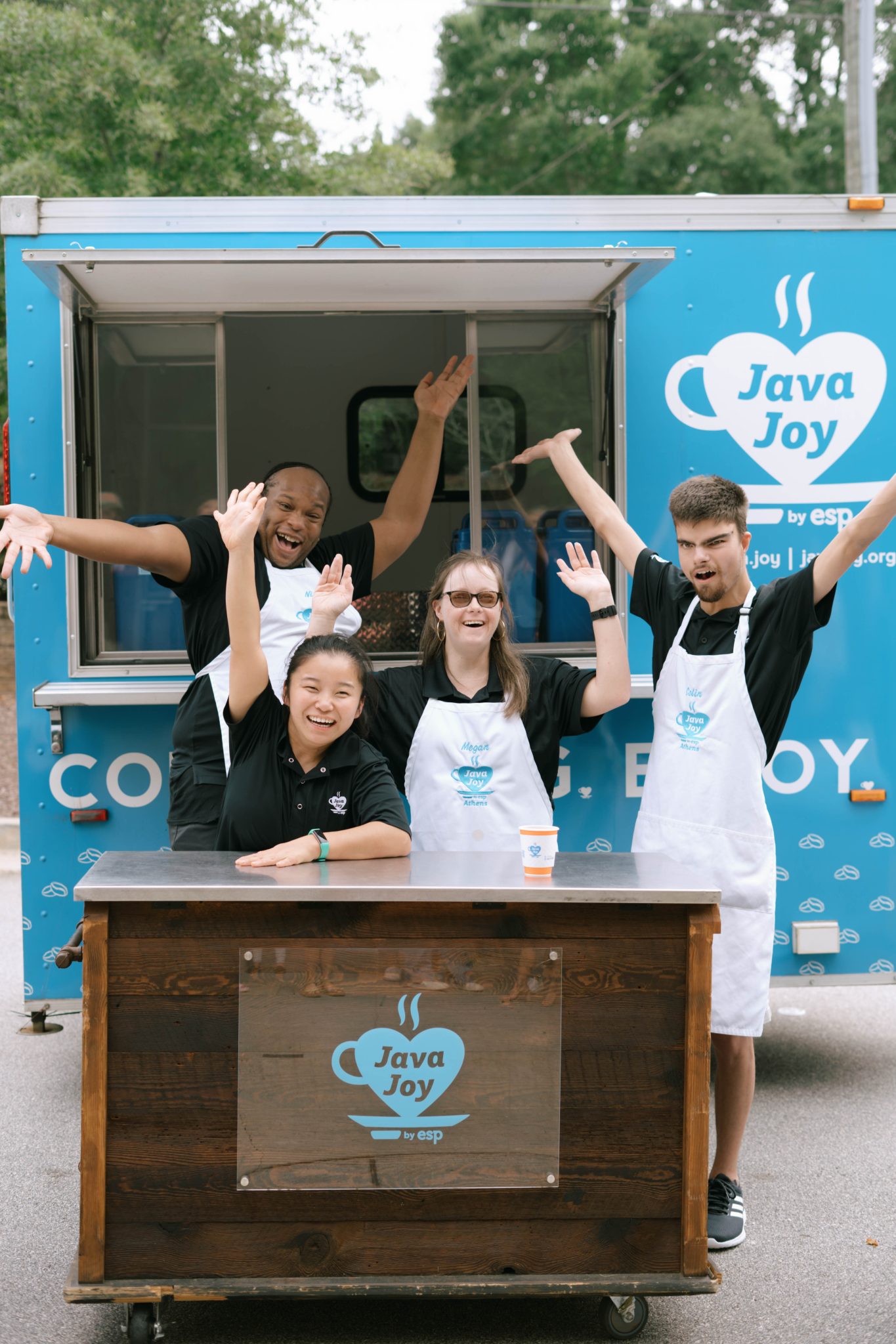 a group of people standing in front of a food truck with Java Joy sign
