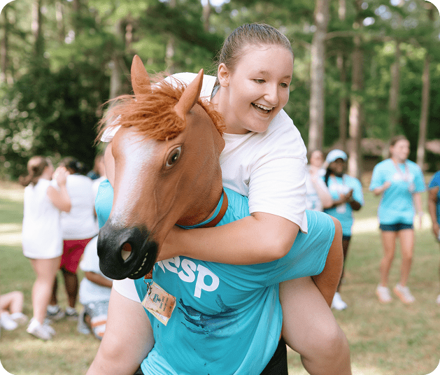 person getting piggy back with a person with horse mask