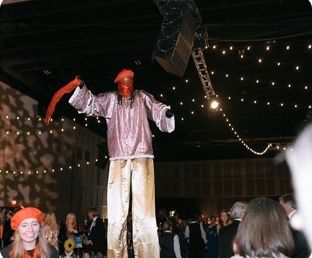 man on stilts at party