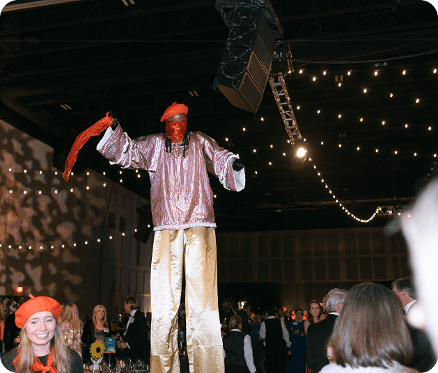 man on stilts at party
